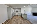 Modern kitchen features stylish cabinets, granite countertops, and an open layout with hardwood floors at 427 Magnolia Run Way, Benson, NC 27504