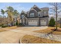 Charming home showcasing a spacious driveway and well-maintained lawn at 437 Creekhurst Pl, Cary, NC 27519