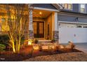 Inviting front entrance featuring double doors, stone accents, and professionally landscaped garden at 437 Creekhurst Pl, Cary, NC 27519