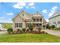 Charming two-story home with manicured front yard and inviting double porches offering serene outdoor spaces at 528 Clifton Blue St, Wake Forest, NC 27587