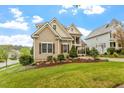 Beautifully landscaped front yard with mature plants surrounding a two-story home, set on a manicured lawn at 528 Clifton Blue St, Wake Forest, NC 27587