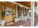 Inviting front porch with rocking chairs and wood door creating a warm welcome at 528 Clifton Blue St, Wake Forest, NC 27587