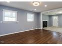 Bright living room features hardwood floors and ample natural light from two windows with blinds at 6 Hawaii Ct, Durham, NC 27713