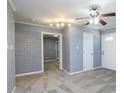 Inviting living room with neutral carpet, a ceiling fan, and a brick wall adjacent to the entry at 6 Hawaii Ct, Durham, NC 27713