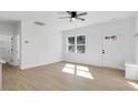 Bright living room with ceiling fan, neutral walls, and wood-look flooring at 604 E Pope St, Dunn, NC 28334