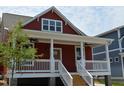 Charming home with a cozy front porch, white railings, and a freshly painted red exterior at 608 Hemlock Ave, Durham, NC 27707