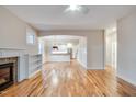 Spacious living room featuring hardwood floors, fireplace, and an open layout leading to the kitchen at 608 Hemlock Ave, Durham, NC 27707