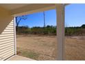 A peaceful backyard view from the covered back porch of this newly built home at 7385 Pilatus Ave, Spring Hope, NC 27882