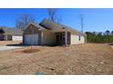 A single story home featuring vinyl siding with a brick accent and a large lawn in the back at 7385 Pilatus Ave, Spring Hope, NC 27882
