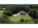 Expansive property showcases a well-maintained home and lush surrounding greenery, blending privacy with natural beauty at 93 Clifton Pond Rd, Louisburg, NC 27549