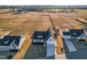 An aerial view of multiple homes and large grassy lots with potential for farming or recreational activities at 95 Watermeadow Dr, Clayton, NC 27520