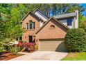 Charming brick home with a two-car garage and mature landscaping at 103 Windhover Dr, Chapel Hill, NC 27514