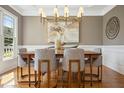 Elegant dining room featuring modern lighting, hardwood floors, and neutral decor at 109 Homegate Cir, Apex, NC 27502