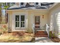 Inviting front porch with brick steps and detailed trim, and stained glass door at 111 Fox View Pl, Cary, NC 27511