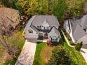 Aerial view of a well-maintained home with lush green lawn and mature trees at 113 Glenmore Rd, Chapel Hill, NC 27516