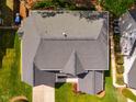 Aerial view of a home with a gray roof, green lawn, and surrounding trees at 113 Glenmore Rd, Chapel Hill, NC 27516