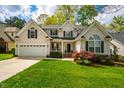 Charming two-story home with a well-manicured lawn and an attached garage at 113 Glenmore Rd, Chapel Hill, NC 27516