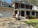 A delightful home with a charming front porch, complemented by a two-car garage and a well-kept front yard at 120 Cypress View Way, Apex, NC 27502