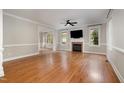 Spacious living room features gleaming hardwood floors, a cozy fireplace, and abundant natural light at 120 Cypress View Way, Apex, NC 27502