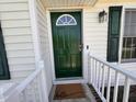 Welcoming front entry features a vibrant green door with a half-moon window at 1204 Amberstone Dr, Knightdale, NC 27545