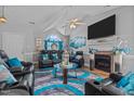 Elegant living room showcasing vaulted ceilings, a fireplace, stylish decor, and comfortable leather seating at 123 Ariel St, Lillington, NC 27546