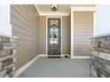Inviting front porch entrance with a stylish door and stone pillars, creating a welcoming ambiance at 149 Logbridge Rd, Chapel Hill, NC 27516