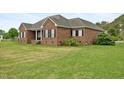 A well-maintained brick house with a spacious yard and manicured lawn at 1500 Antioch Rd, Rocky Mount, NC 27801