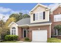 Inviting two-story brick home with attached garage, complemented by manicured landscaping and mature trees at 1515 Poets Glade Dr, Apex, NC 27523