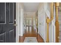 Grand foyer with hardwood floors, staircase, and views into the living and dining areas at 1515 Poets Glade Dr, Apex, NC 27523