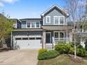 Charming two-story home with a two-car garage, inviting front porch, and manicured landscaping at 173 Hawk Point Rd, Chapel Hill, NC 27516