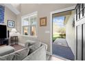 Bright living room featuring a large window and access to the outdoors with a comfortable seating area at 20 Izuba Day Dr, Timberlake, NC 27583