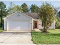 Inviting single-story home with a well-maintained lawn and attached garage in a Gathering-friendly neighborhood at 202 Providence Hall Dr, Sanford, NC 27330