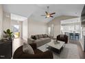 Open-concept living room featuring vaulted ceilings, a ceiling fan, and seamless flow into the kitchen at 205 Mcclellan Trl, Mebane, NC 27302