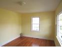 Bright bedroom with hardwood floors, neutral walls, and natural light from the window at 2117 Wrenn St, Burlington, NC 27215