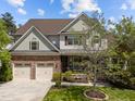 Lovely two-story home featuring stone accents, a two-car garage, and landscaped front yard at 224 Clear River Pl, Cary, NC 27519