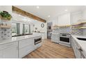 Bright kitchen with a large island, stylish backsplash, stainless steel appliances, and open layout at 230 Bradley Dr, Benson, NC 27504