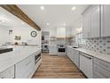 Spacious kitchen featuring an island, wooden accents, and modern appliances against patterned backsplash at 230 Bradley Dr, Benson, NC 27504
