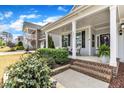 Inviting front porch features brick steps, comfy chairs, and lush landscaping at 2321 Swansea Ln, Apex, NC 27502