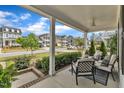 Relaxing front porch area with comfortable seating offers serene neighborhood views at 2321 Swansea Ln, Apex, NC 27502