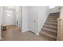 Welcoming entryway with hardwood floors, stairs to the second level, and ample natural light at 254 W Odell Ln, Zebulon, NC 27597