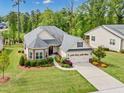 Stunning aerial view of a well-maintained home with lush landscaping and a long driveway at 2613 Beckwith Rd, Apex, NC 27523