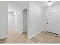 Bright entryway with a white door, white walls, and wood-look floors at 2709 Hidden Hollow Dr, Durham, NC 27703