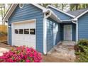 A close-up of the blue home, showing the garage and the front door at 2709 Hidden Hollow Dr, Durham, NC 27703