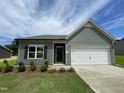 Charming one-story home features a two-car garage, manicured lawn and tasteful landscaping at 288 Olivia Crossing Ct # 10, Four Oaks, NC 27524