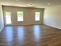 Bright living room features hardwood floors, recessed lighting, and plenty of natural light at 288 Olivia Crossing Ct # 10, Four Oaks, NC 27524