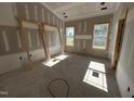 Bedroom features drywall, trimwork, and natural light from the windows overlooking the neighborhood at 2895 Bakers Chapel Rd, Smithfield, NC 27577