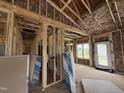 Bright, spacious living room with framing and wiring in progress, featuring natural light from the window at 2895 Bakers Chapel Rd, Smithfield, NC 27577