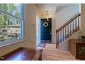 Welcoming foyer with hardwood floors, staircase, wreath, and a view of the exterior at 300 Nc 54 Highway # E2, Carrboro, NC 27510