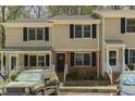 Charming townhome with covered porch, neutral siding, black shutters, and convenient parking at 300 Nc 54 Highway # E2, Carrboro, NC 27510