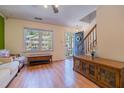 Inviting living room featuring hardwood floors, staircase, bright windows, and a blue front door at 300 Nc 54 Highway # E2, Carrboro, NC 27510